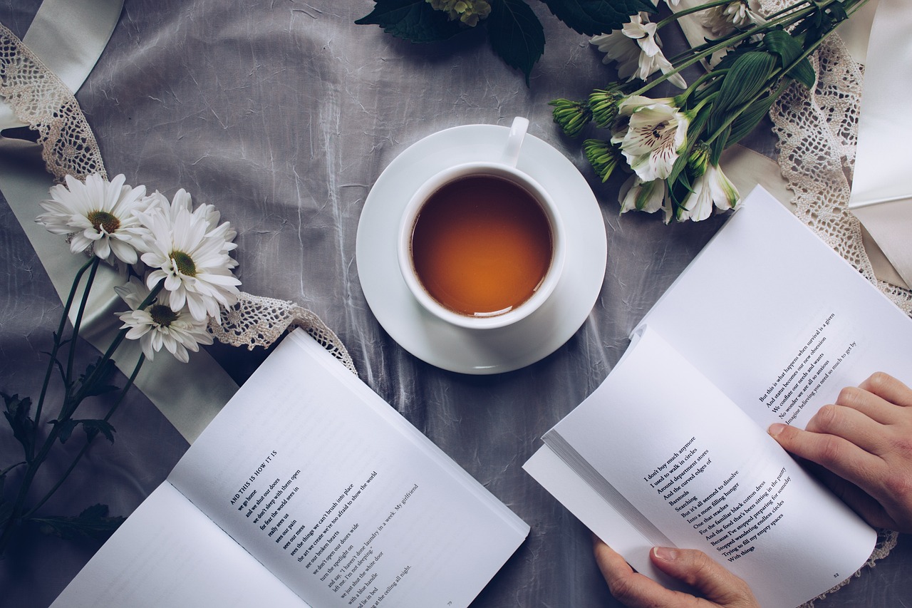 2 livres de poésies ouverts autour d'une tasse de thé
